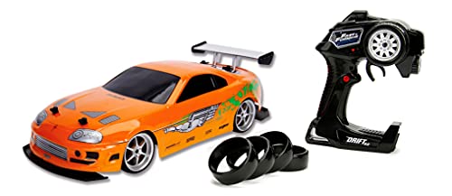 Jada Toys 253209003 Toys Fast & Furious RC-Auto, Drift 1995 Toyota Supra, Turbo, Driftfunktion,Allradantrieb,Ferngesteuertes Auto,2-Kanal Funkfernbedienung,USB Ladefunktion,4 Ersatzreifen,1:10, orange von Jada Toys