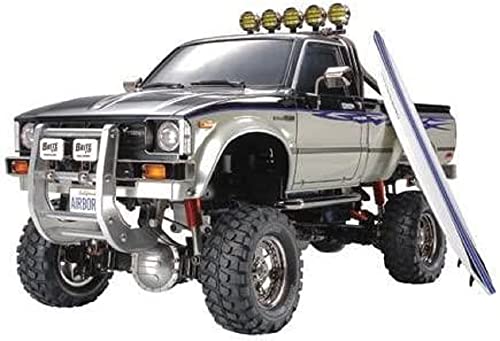 TAMIYA TMYTAM58397 1:10 RC Toyota HiLux HighLift 4x4 3-Gang - ferngesteuertes Auto - inkl. Surfbrett - Offroad - Pick Up -Elektromotor - Modellbausatz - Metallgetriebe - unlackiert - 58397, Schwarz von TAMIYA